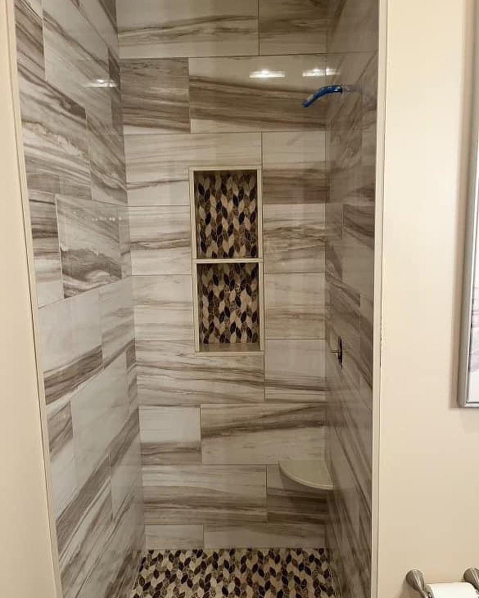Marble shower with mosaic niche